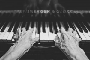 Older hands playing piano